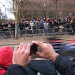 F1 car passes by crowd